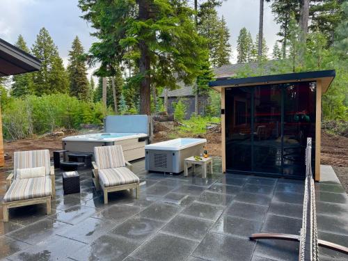 a patio with a table and chairs and a building at Violet Retreat in McCall