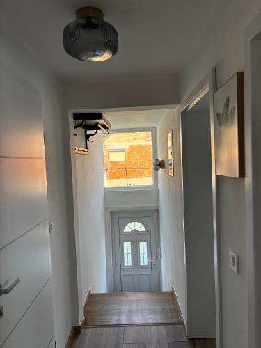 a hallway with a door and a window in a house at Kraljev Vrh Apartments in Kraljev Vrh