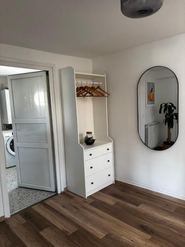 a white room with a dresser and a mirror at Kraljev Vrh Apartments in Kraljev Vrh