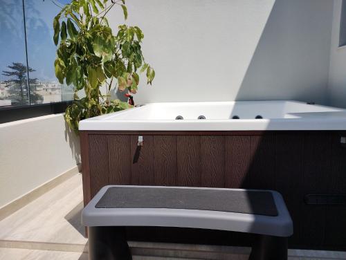 a bathroom with a sink and a potted plant at Biliaba in Rhodes Town