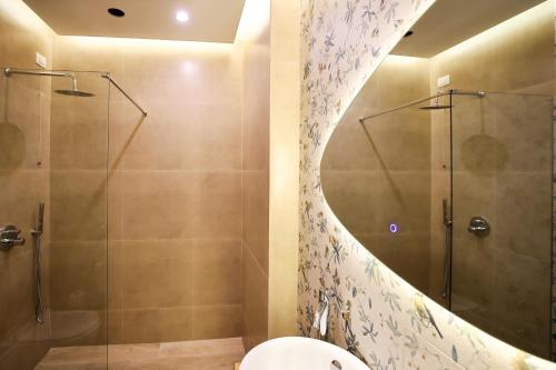 a bathroom with a shower and a toilet at The MONT BOUTIQUE HOTEL in Shkodër