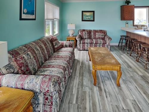a living room with a couch and a table at Hoff 1 in Topsail Beach