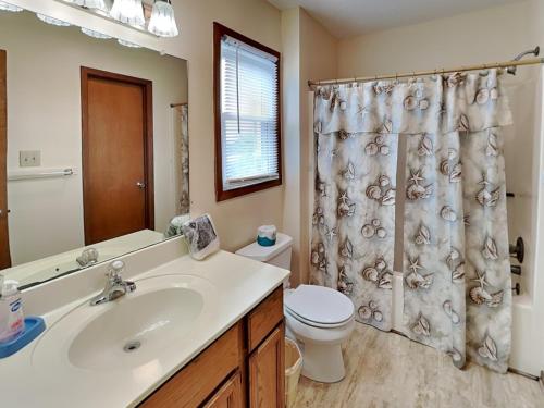 a bathroom with a sink and a toilet and a shower at Hoff 1 in Topsail Beach