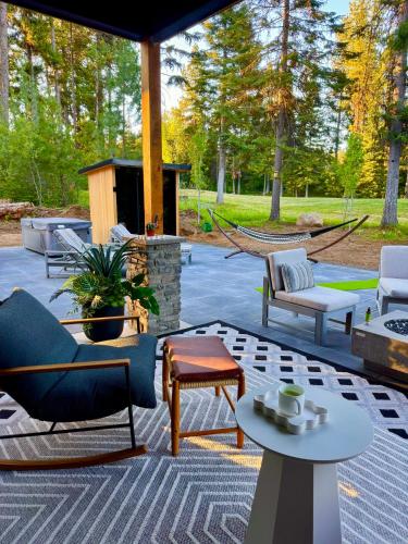 a patio with chairs and tables and a hammock at Violet Retreat in McCall