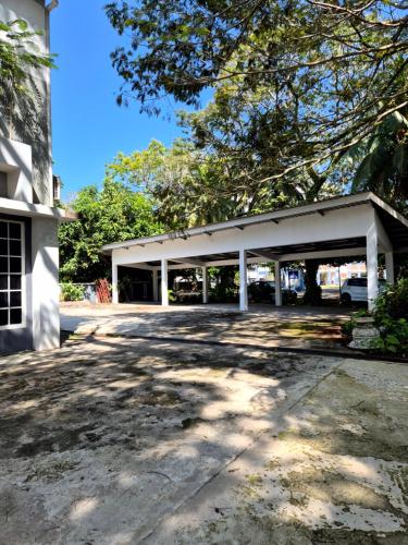 a large white building with a parking lot at Clover Studiostay in Labuan