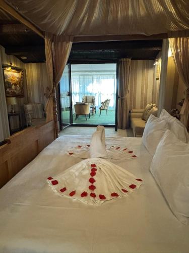 a bed with a dress with red roses on it at Masía De Lacy in Museros