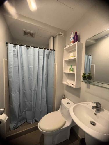 a bathroom with a white toilet and a sink at Louritto Studio Type Condo at Avida Towers Riala Tower 3 in Cebu City