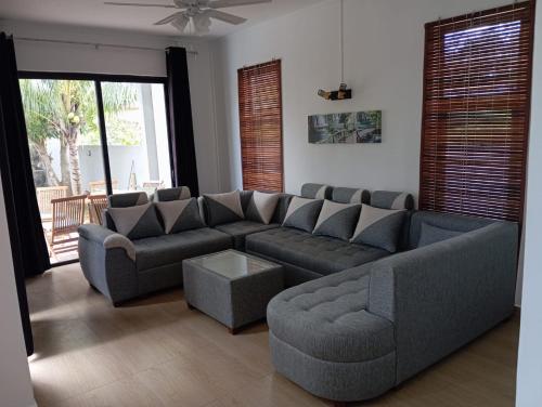 a living room with a couch and a table at Villa Coco in Trou aux Biches