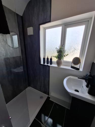 a bathroom with a sink and a window at Florence House in Bradford