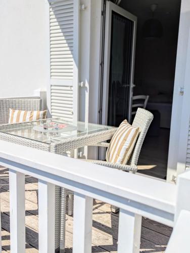 a glass table and chairs sitting on a balcony at Haus Grünewald Unsleben in Unsleben