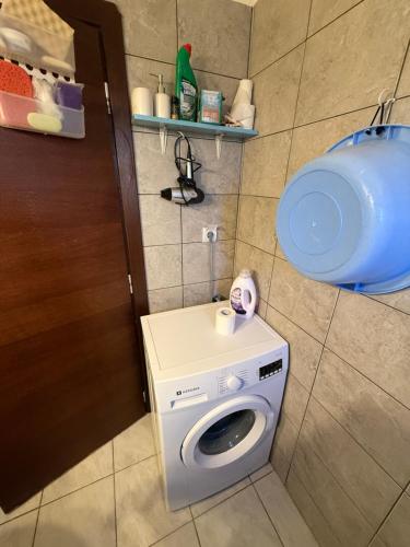 a washing machine in a bathroom with a door at Modern 1-bedroom with BBQ & Roof Garden near Beach in Stalos