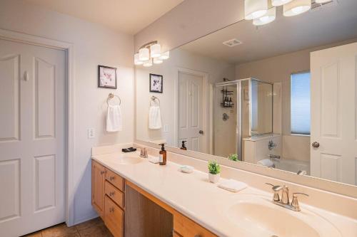 a bathroom with a sink and a large mirror at NEW Desert Daze, near Golf, Heated Pool+Spa, 12ppl in Scottsdale