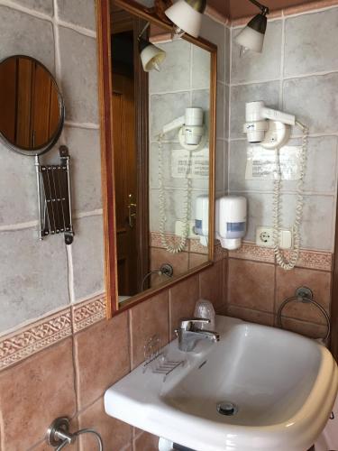 a bathroom with a sink and a mirror at Aparthotel Es de Don Joan in Unha