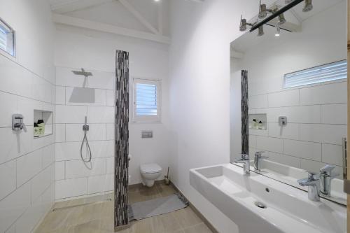 a bathroom with a tub and a sink and a toilet at Esperon in Stellenbosch