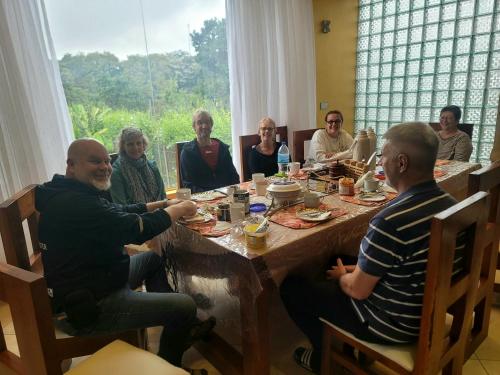 a group of people sitting around a table at Simba Villa in Arusha