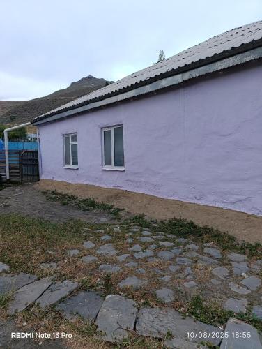 a white building with a window on the side of it at Riverside in Xınalıq