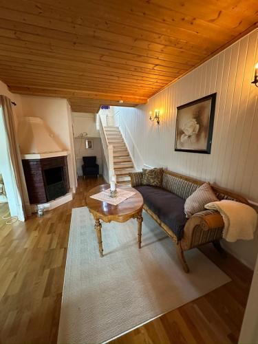 a living room with a couch and a table at Château Fossen 3 in Grong
