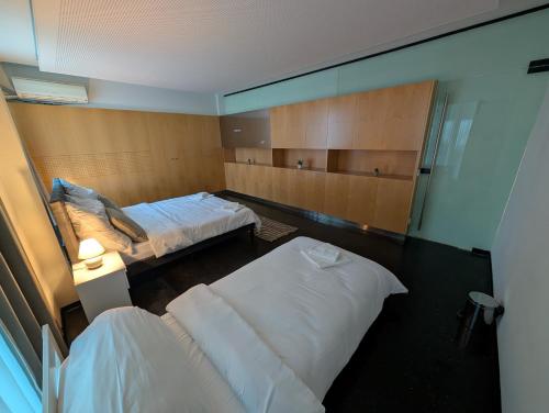 a hotel room with two beds and a mirror at Bed'n Go in Bregenz
