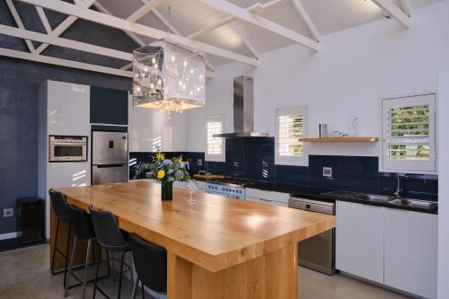 a large kitchen with a wooden table in it at Esperon in Stellenbosch