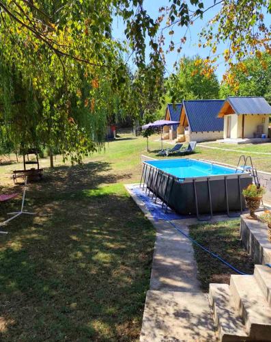 a backyard with a swimming pool and a house at Dunavska Priča in Negotin