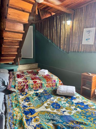 a bed with a colorful quilt in a room at Refugio del Cielo # in Sayulita