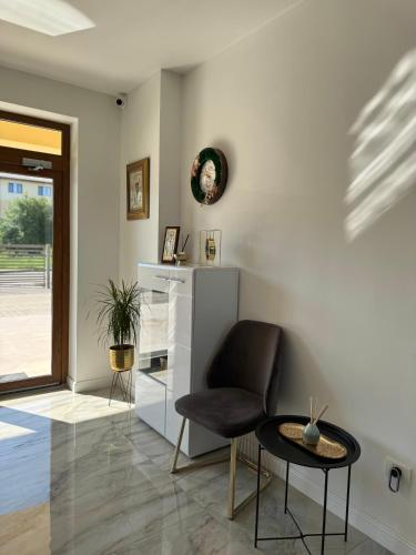 a living room with a chair and a table at Pensiune Simona in Deva