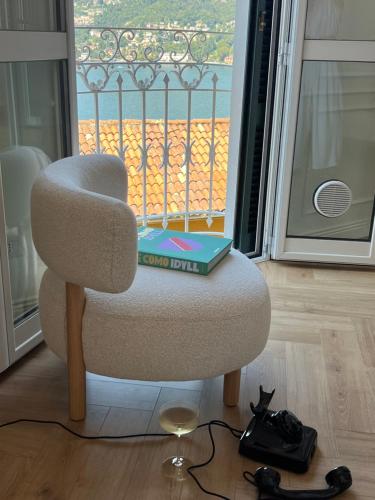 a chair with a book sitting on top of it at LEtoile du Lac in Blevio