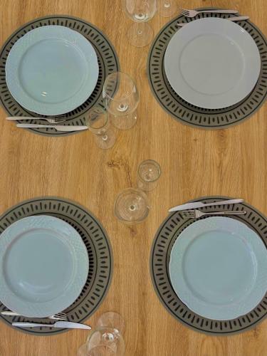 a group of plates and wine glasses on a table at La Casa di Anna, a un passo dal mare in Rapallo