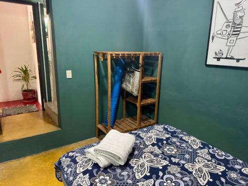 a bedroom with a bed and a shelf with towels at Refugio del Cielo # in Sayulita