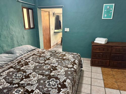 a bedroom with a bed and a dresser in it at Refugio del Cielo # in Sayulita