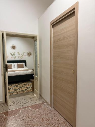 a door leading to a bedroom with a bed at La dimora degli ulivi in Torre Santa Susanna