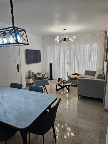 a large living room with a table and chairs at Modern 3BR Apmt Near Airport & Beach in San Isidro