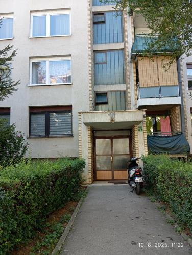 a motorcycle parked in front of a building at Skyflat Dobrinja by S&A in Sarajevo
