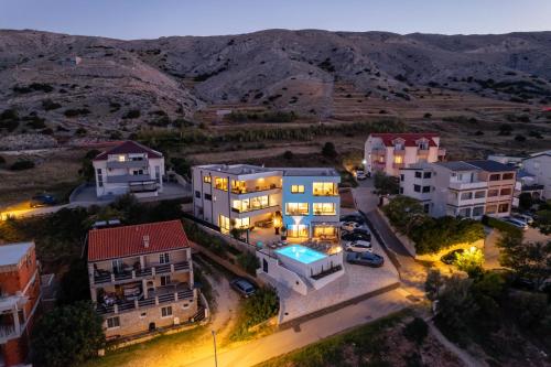 an aerial view of a building with mountains in the background at Babic Apartments in Pag