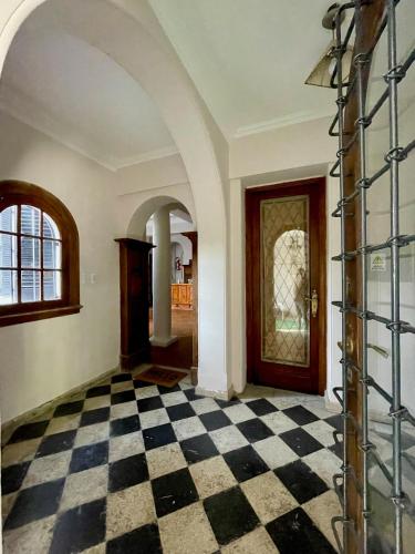 a room with a black and white checkered floor at Hostel Plaza in Mendoza