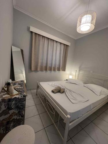 a bedroom with a bed in a room with a window at Handra Apartment Seaview in Kos