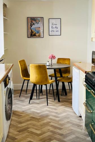 a kitchen with a dining room table and chairs at Home away from home-business & leisure travellers in Northampton