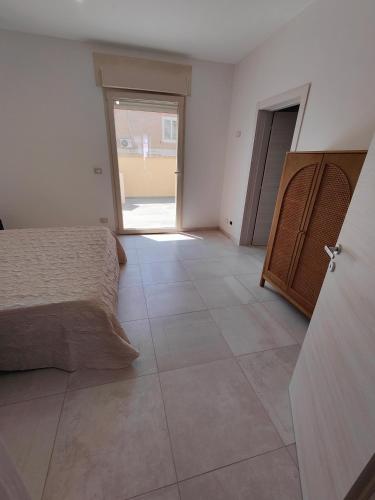a bedroom with a bed and a tiled floor at Borgo Antico Guest House in Ruffano