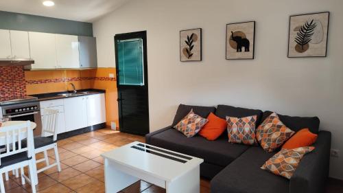 a living room with a couch and a kitchen at A Devesa in Noya