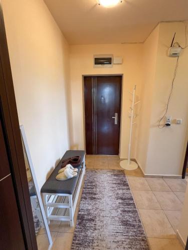 a room with a door and a chair and a hallway at Alpine Lodge Chalet in Bansko in Bansko