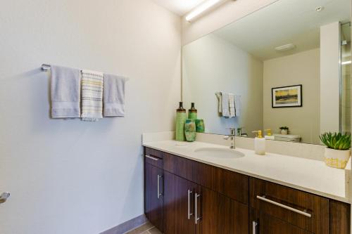 a bathroom with a sink and a mirror at Fort Myers 2BR Condo Pool BBQ Area in Estero