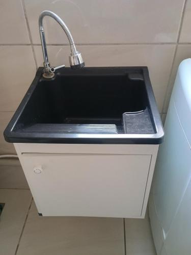 a sink with a faucet in a bathroom at La Bela Casa in Catanduva