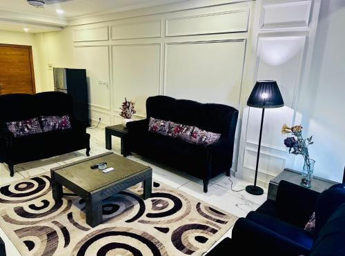a living room with two couches and a coffee table at Noir Escape in Rawalpindi