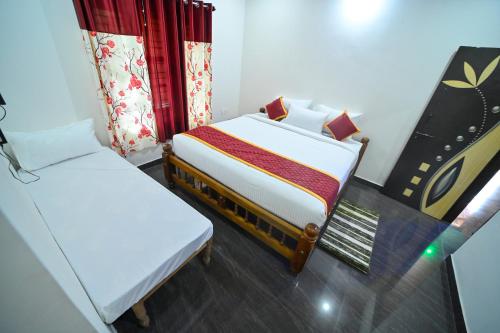 a small room with two beds and a window at Elephant path Coorg villas in Suntikoppa