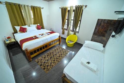 a bedroom with a bed and a couch in it at Elephant path Coorg villas in Suntikoppa