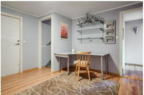 a dining room with a table and a chair at Peaceful villa in nature with own beach in Hindås