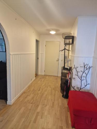 an empty living room with a hard wood floor at Peaceful villa in nature with own beach in Hindås