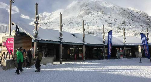 a group of people standing outside of a building in the snow at Appart 5 pers, pied des pistes à Piau-Engaly, au coeur de la station in La Celle-sous-Gouzon