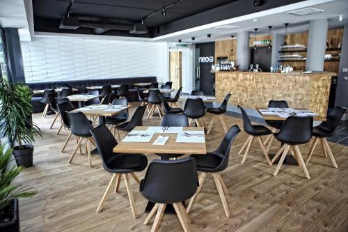 a dining room with wooden tables and chairs at Neo Premium Apartments in Sárvár