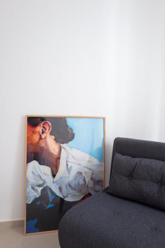 a picture on the wall next to a bed at Casa di Luce in Gioia del Colle